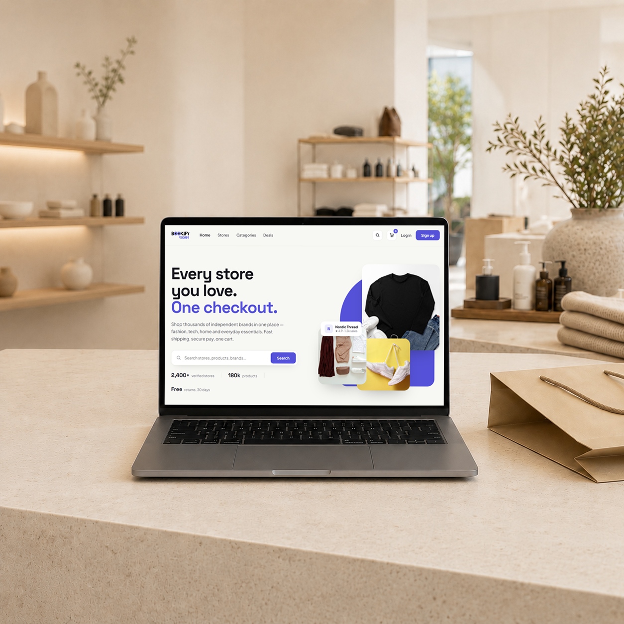A laptop on a retail counter showing the Bookify Stores marketplace